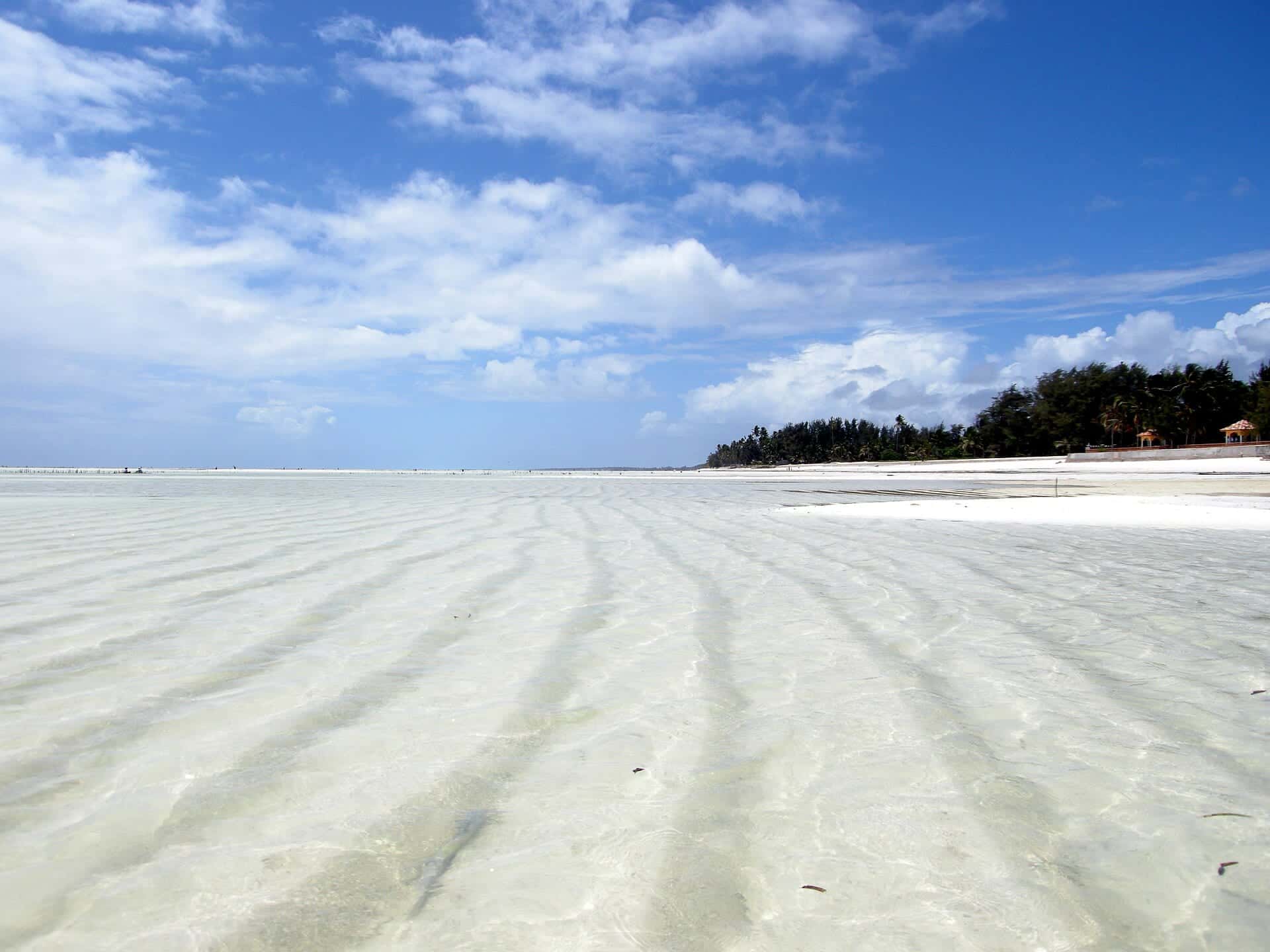 Shallow turquoise water at low tide on Paje beach