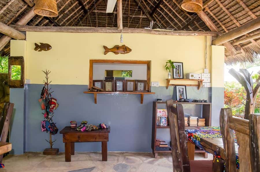 Dining area with colourful table cloths inside the thatched restaurant
