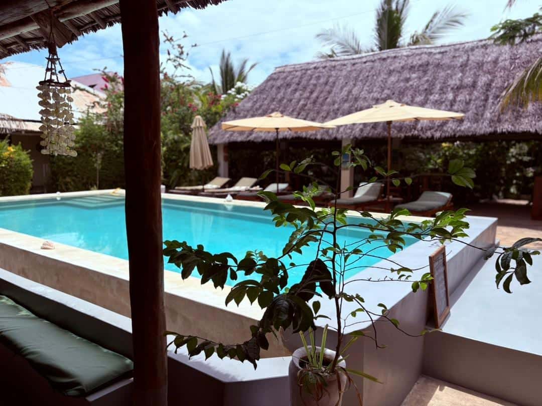 Pool and shaded sun loungers with parasols