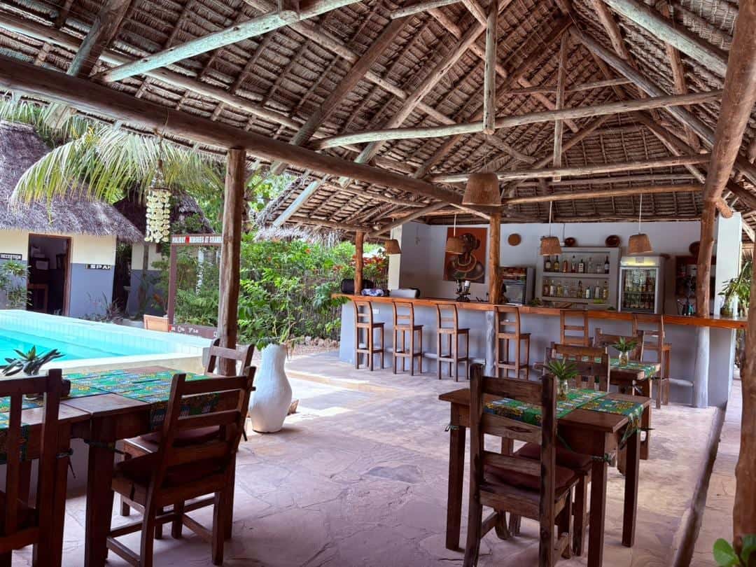 Restaurant tables and bar overlooking the swimming pool
