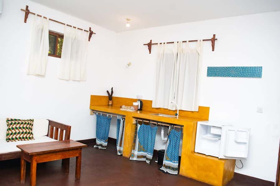 Room with a kitchenette, small table and fridge