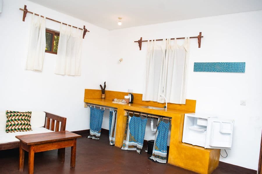 Room with a kitchenette, small table and fridge